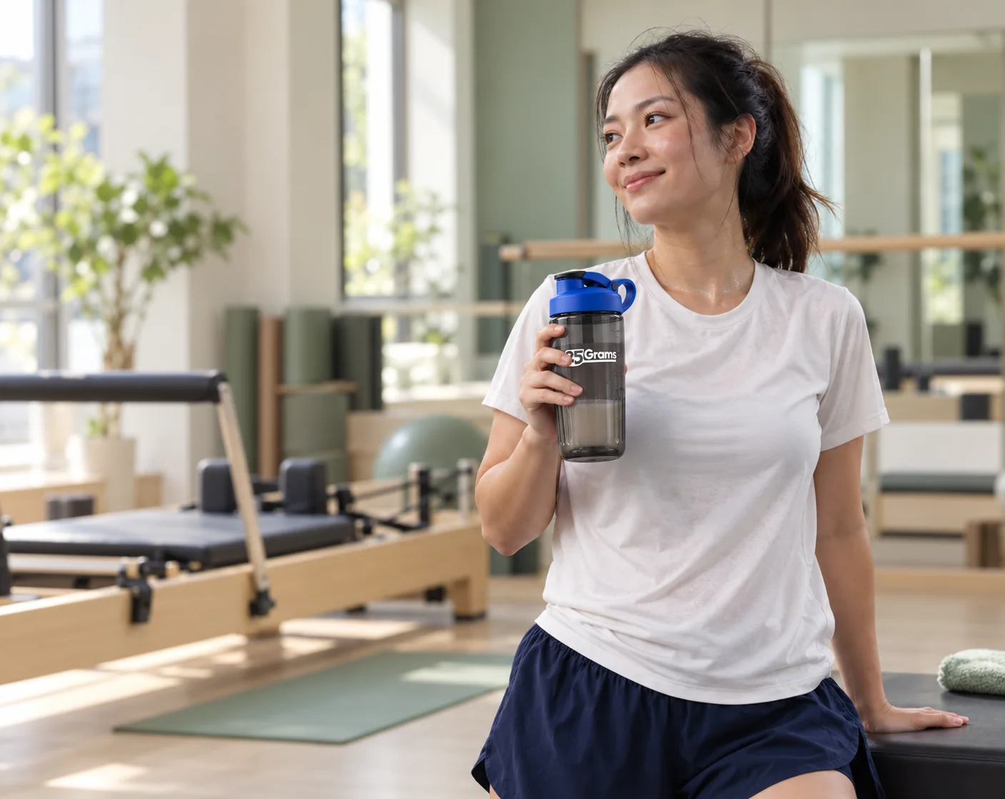 Woman holding a 25 Grams shaker after a workout